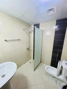 a bathroom with a sink and a shower and a toilet at Couples Loft Partition CLOSE to MALL OF EMIRATES METRO in Dubai
