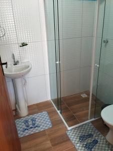 a bathroom with a shower and a sink and a toilet at Casa Morada da Praia 03 in Maragogi
