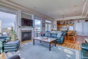 a living room with blue couches and a fireplace at Arbor House North in Yachats
