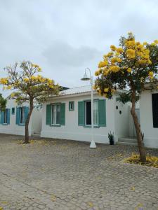 a house with two trees in front of it at Casa en Playa Privada - A pocos minutos de General Villamil Playas in Posorja