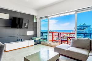 a living room with a view of the ocean at Deck 12 - 807 in Puerto Vallarta