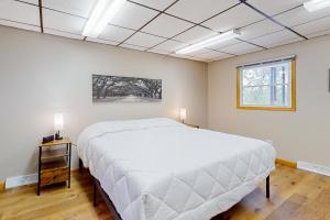 a bedroom with a large white bed and a window at Baraboo's Enchantment - Main in Baraboo