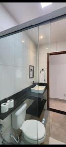 a bathroom with a toilet and a sink at Studio RD in Angra dos Reis