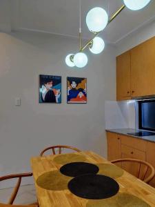 a kitchen with a wooden table and some pictures on the wall at Benita At the Plaza in Dolores