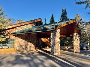 a house with a garage with a car parked at Whitetail Lodge in Saint Germain