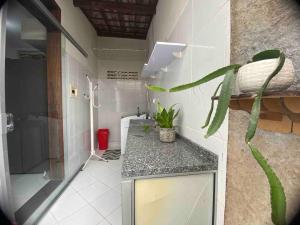 a bathroom with a sink and a shower and a toilet at Duplex em condomínio fechado in Campina Grande
