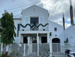 a white house with a fence in front of it at Benita At the Plaza in Dolores