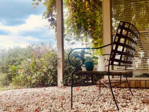 a chair sitting on a porch with a table at Yarra Gem in Yarra Glen