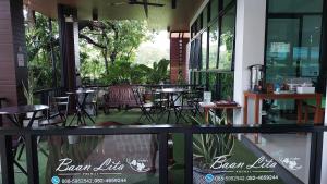 a patio with tables and chairs in a restaurant at Baan Lita in Phimai