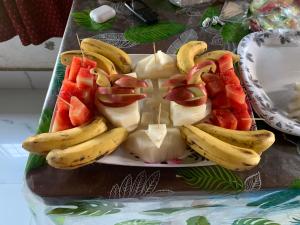 a plate with bananas and fruit on a table at Sarkar Villa Homestay in Kolkata