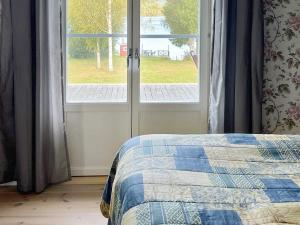 a bedroom with a bed next to a window at 4 star holiday home in TRÖNÖDAL-By Traum in Vallsta