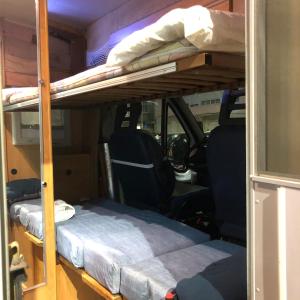 a room with two bunk beds in a van at Sempre pronta para férias in Amadora