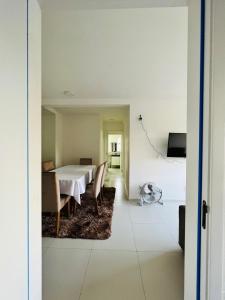 a dining room with a white table and chairs at Apartamento novo zona leste. in Teresina