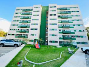 a large white building with a lawn in front of it at Apartamento novo zona leste. in Teresina