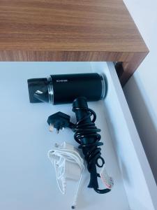 a black hair dryer sitting on top of a table at The DreamHouse Homestay in Lahad Datu