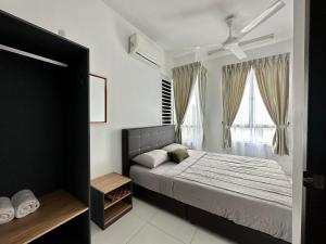 a bedroom with a bed and a window at Nureenas Residence Condominium in Ayer Keroh