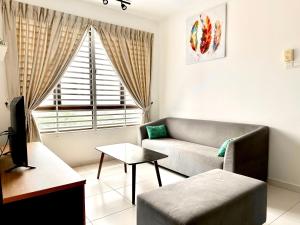 a living room with a couch and a window at Nureenas Residence Condominium in Ayer Keroh