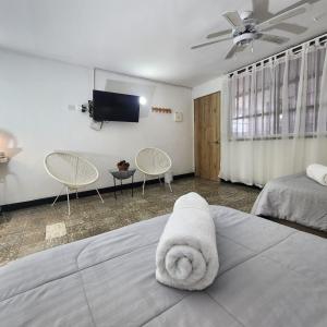 a hotel room with a bed with a towel at Casa Matuna - Cartagena in Cartagena de Indias