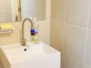a bathroom sink with a bottle of soap on it at S4 Modern Sunway Geo 1-7pax Sunway Medical Centre in Petaling Jaya