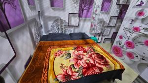 a bedroom with a bed with a colorful blanket at Vrindavan Nivas -Near Prem mandir bankey bihari in Vrindāvan