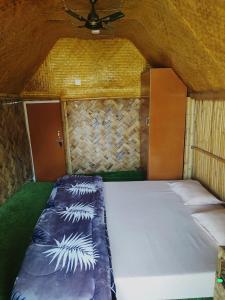 a bed in the back of a small room at AVA Resort, Kaziranga in Bokakhat