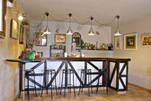 a bar in a restaurant with stools around it at Posada Real El Sendero del Agua in Trefacio +56 photos