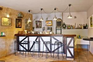 a bar with stools around it in a room at Posada Real El Sendero del Agua in Trefacio