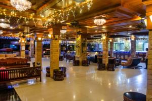 a lobby with chairs and chandeliers in a building at Diva Patong Hotel in Patong Beach