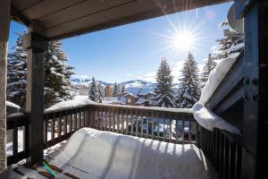 a snow covered balcony with a view of the mountains at Fairway Nine 4369 - Updated Condo in the Heart of Elkhorn Resort in Sun Valley