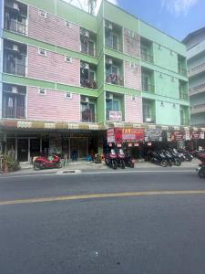 a building with motorcycles parked on the side of a street at T&R Wagner Appartaments in Patong Beach