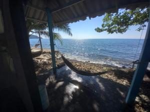 a hammock hanging from a house on the beach at Blue Sky Resort in Ko Chang