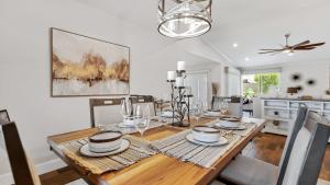 a dining room with a table with plates and glasses at Luxe Central Scottsdale 4 bdrm w Backyard Oasis in Scottsdale