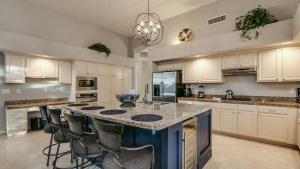a kitchen with a large island with a counter top at North Scottsdale Sanctuary w Htd Pool and Views in Scottsdale