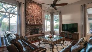 a living room with leather furniture and a fireplace at North Scottsdale Sanctuary w Htd Pool and Views in Scottsdale