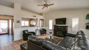 a living room with a leather couch and a fireplace at Scottsdale Kierland 3 Bdrm with Sparkling Pool in Scottsdale