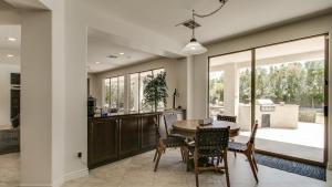 a kitchen and dining room with a table and chairs at Amazing Litchfield Estate With Backyard Oasis in Litchfield Park