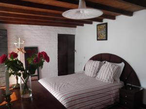 a bedroom with a bed with a vase of flowers on a table at La Maison des Artistes in Essaouira +86 photos