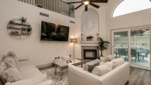 a living room with two white couches and a fireplace at Newly Renovated 4 Bedroom Retreat wPool in Phoenix
