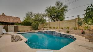 a swimming pool in a yard next to a house at Newly Renovated 4 Bedroom Retreat wPool in Phoenix