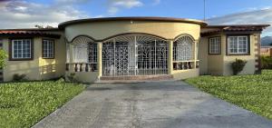 a house with a gate in the front of it at Eagles Nest Villa House AC TV WIFI Fan Luxury Modern in Albion