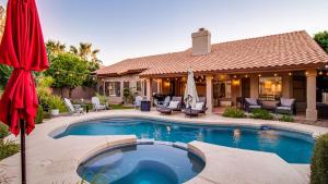 a house with a swimming pool in front of a house at Stunning North Scottsdale Luxury Home wHTD Pool in Phoenix