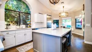 a large kitchen with white cabinets and a large island at Stunning North Scottsdale Luxury Home wHTD Pool in Phoenix