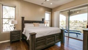 a bedroom with a bed and a balcony at Fabulous 4-Bdrm WBreathtaking Views & Pool in Fountain Hills