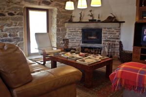 a living room with a couch and a fireplace at Posada Real El Sendero del Agua in Trefacio