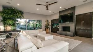 a living room with a white couch and a tv at Stunning Private and Modern N Scottsdale Estate in Scottsdale