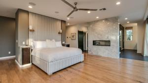 a bedroom with a large bed and a fireplace at Stunning Private and Modern N Scottsdale Estate in Scottsdale
