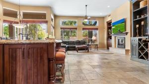a large kitchen with a bar and a living room at Southwestern 4 Bdrm Retreat HTD Pool Game Room in Phoenix