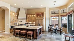 a large kitchen with a large island with bar stools at Southwestern 4 Bdrm Retreat HTD Pool Game Room in Phoenix