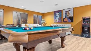 a pool table in a living room with yellow walls at Massive North Scottsdale 6 bdrm w Oasis Backyard in Phoenix