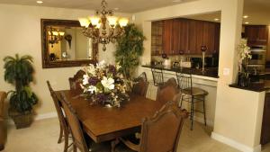 a dining room with a table with flowers on it at The Palm in Scottsdale